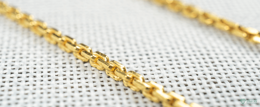 PJ-Gold chain necklaces over white sack background